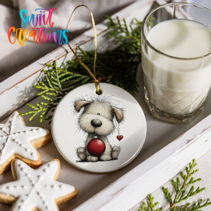 fluffy Christmas puppy holding a red ornament ceramic Christmas ornament styled with holiday cookies and a candle