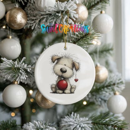 fluffy Christmas puppy holding a red ornament ceramic Christmas ornament hanging on a frosted tree with ornaments