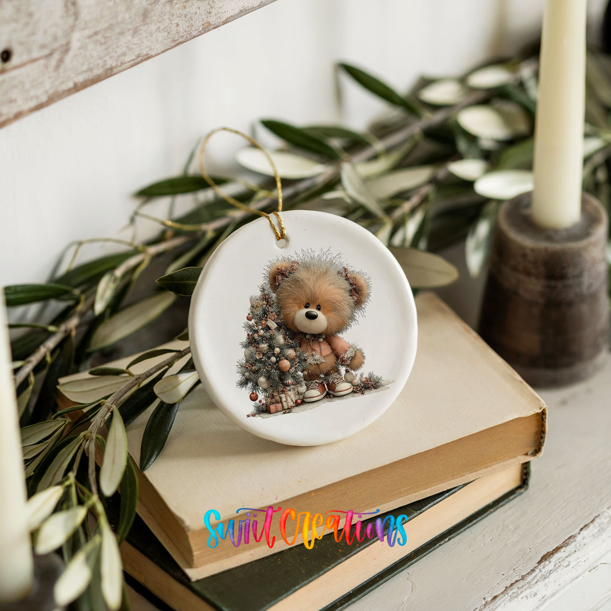 teddy bear sitting beside a decorated Christmas tree ceramic Christmas ornament styled on stacked books with greenery