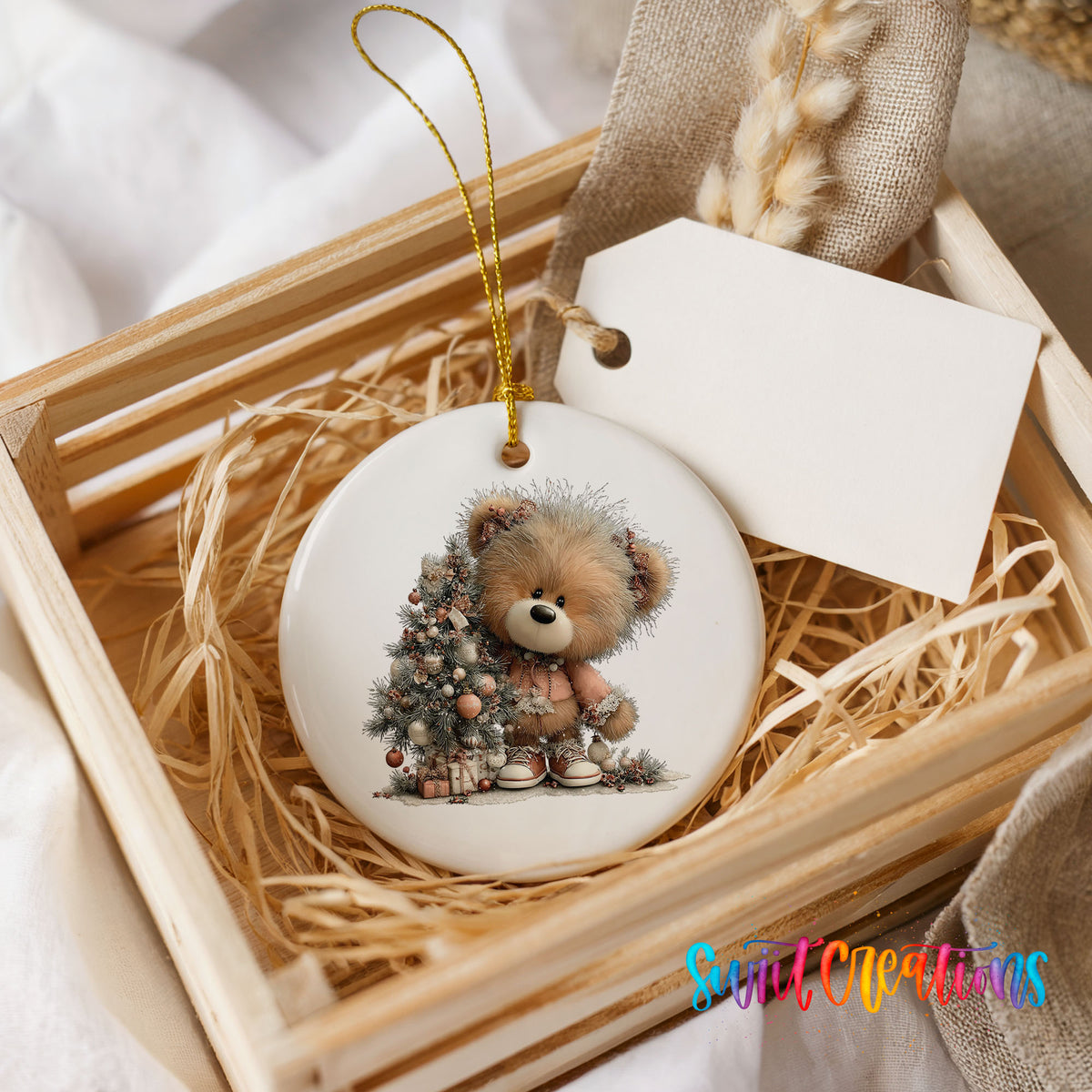 teddy bear sitting beside a decorated Christmas tree ceramic Christmas ornament displayed in a wooden gift crate