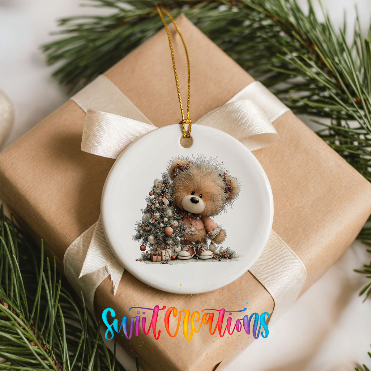 teddy bear sitting beside a decorated Christmas tree ceramic Christmas ornament displayed on a wrapped Christmas gift