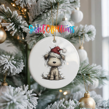 fluffy puppy in a Santa hat ceramic Christmas ornament hanging on a frosted Christmas tree