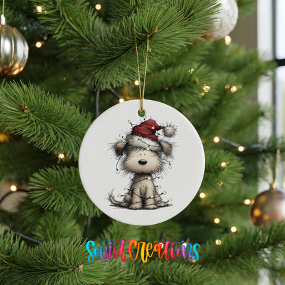 fluffy puppy in a Santa hat ceramic Christmas ornament hanging on a lit Christmas tree