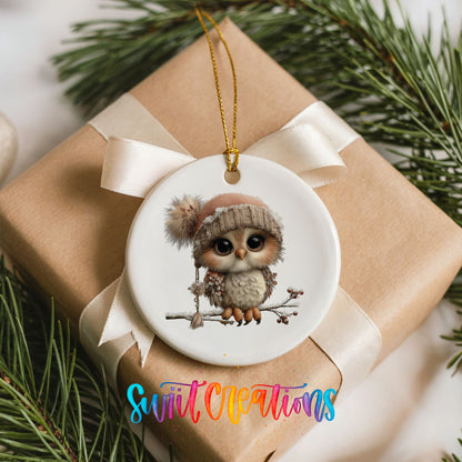 winter owl perched on a snowy branch ceramic Christmas ornament displayed on a wrapped Christmas gift