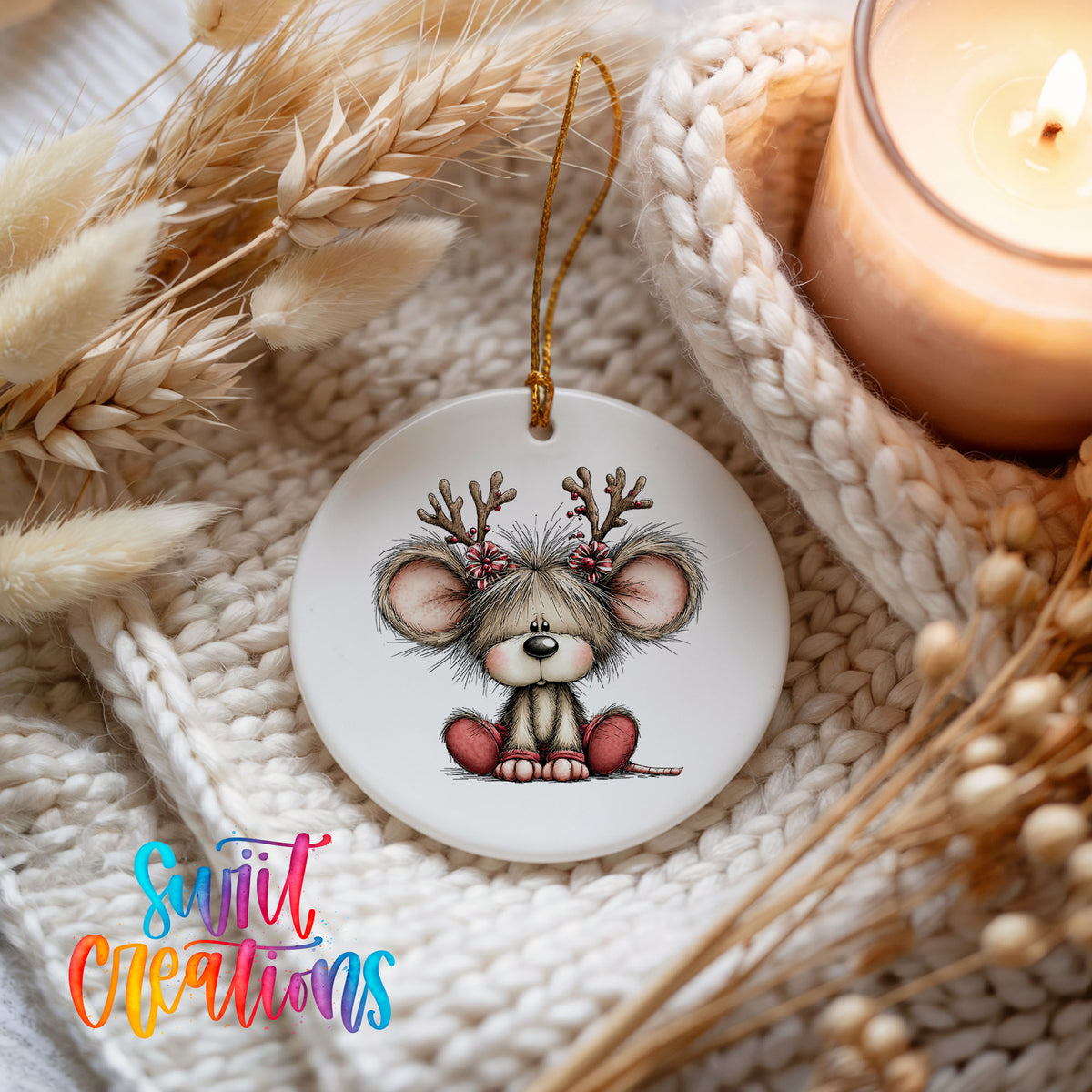 Christmas mouse wearing reindeer antlers and a red scarf ceramic Christmas ornament styled on a cozy knit blanket