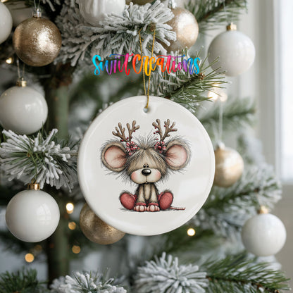 Christmas mouse wearing reindeer antlers and a red scarf ceramic Christmas ornament hanging on a frosted tree with ornaments