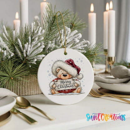 teddy bear holding a Merry Christmas sign ceramic Christmas ornament shown in a holiday table setting