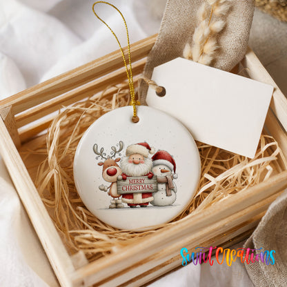Santa Claus with a reindeer and snowman holding a Merry Christmas sign ceramic Christmas ornament displayed in a wooden gift crate