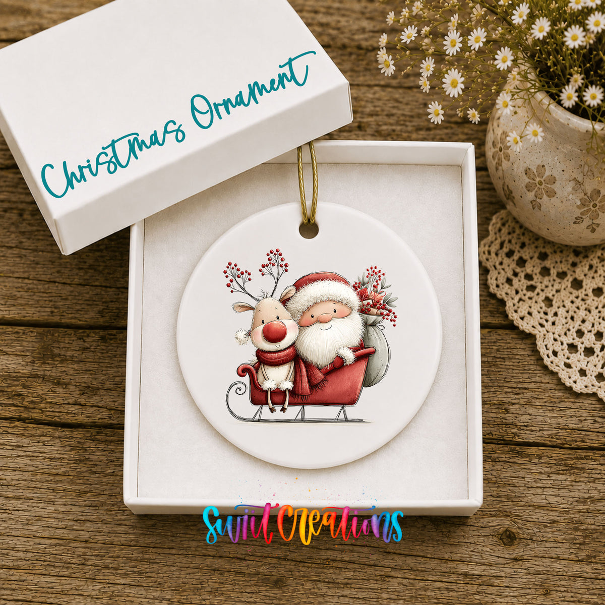 Santa Claus riding in a sleigh with a reindeer ceramic Christmas ornament presented in a gift box