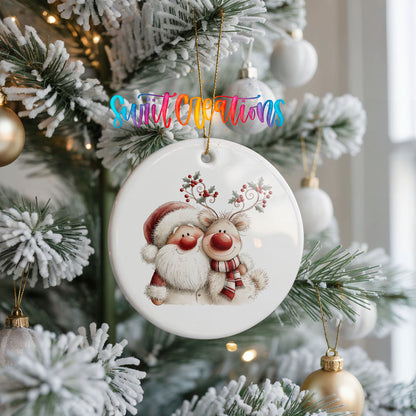 Santa Claus hugging a reindeer with holly antlers ceramic Christmas ornament hanging on a frosted Christmas tree