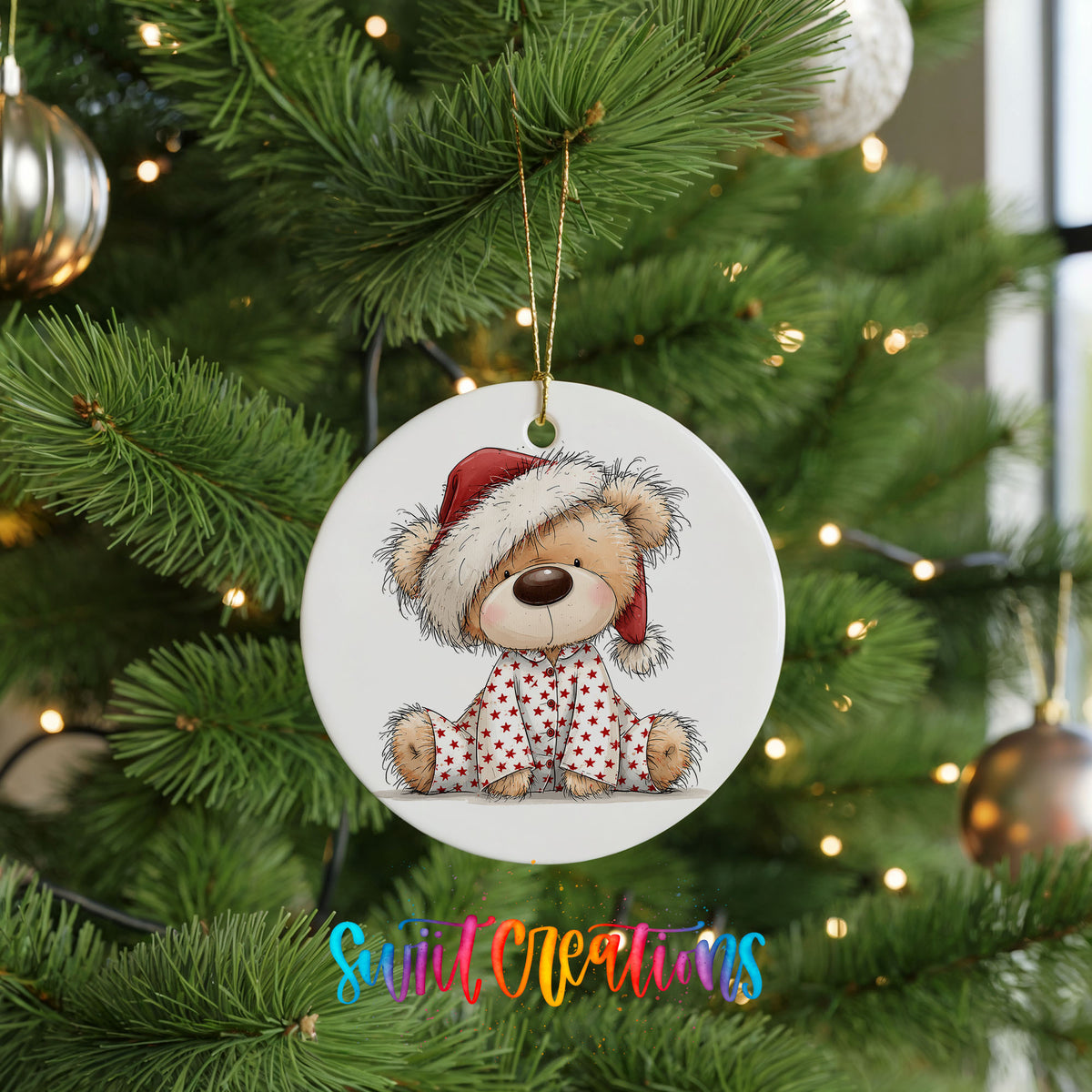 teddy bear in a Santa hat and pink polka dot scarf ceramic Christmas ornament hanging on a lit Christmas tree