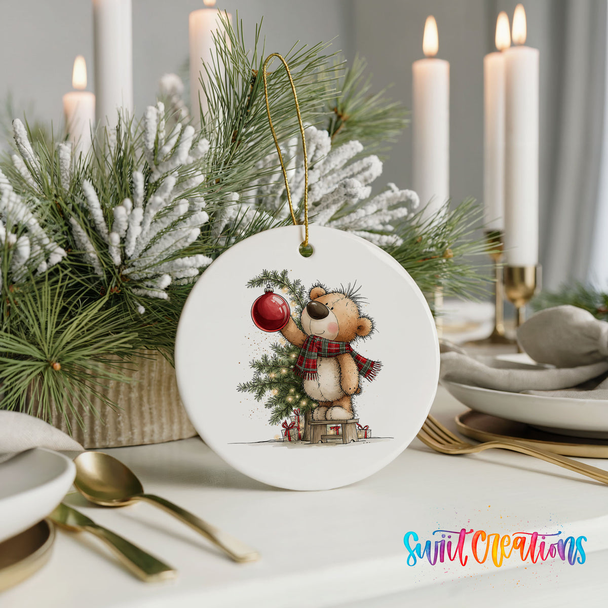 teddy bear holding a red ornament beside a Christmas tree ceramic Christmas ornament shown in a holiday table setting