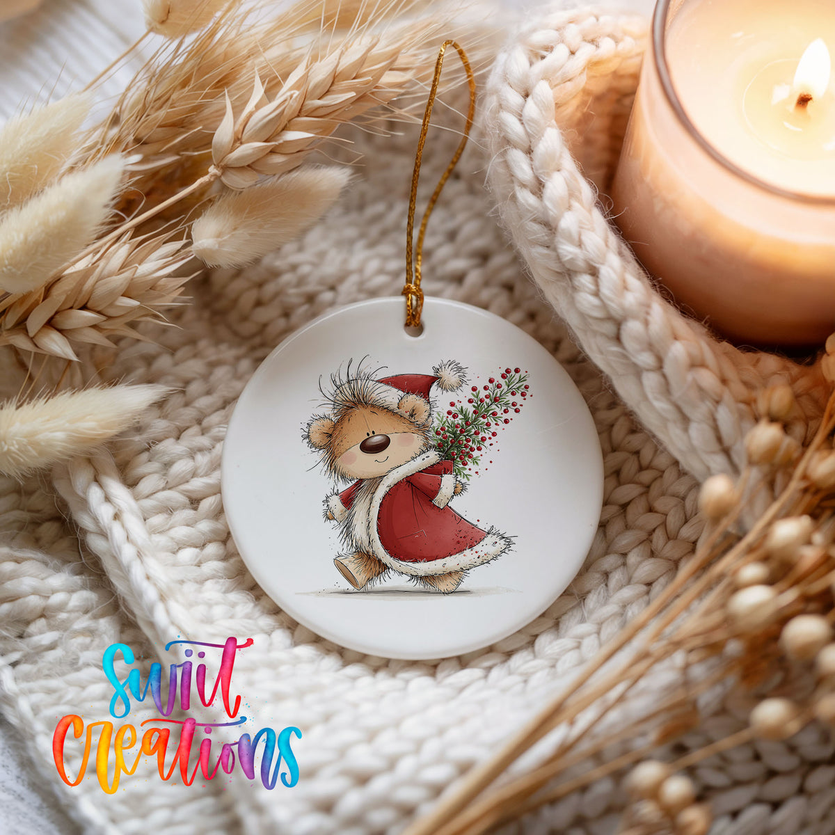 teddy bear carrying a red Christmas sack with winter greenery ceramic Christmas ornament styled on a cozy knit blanket