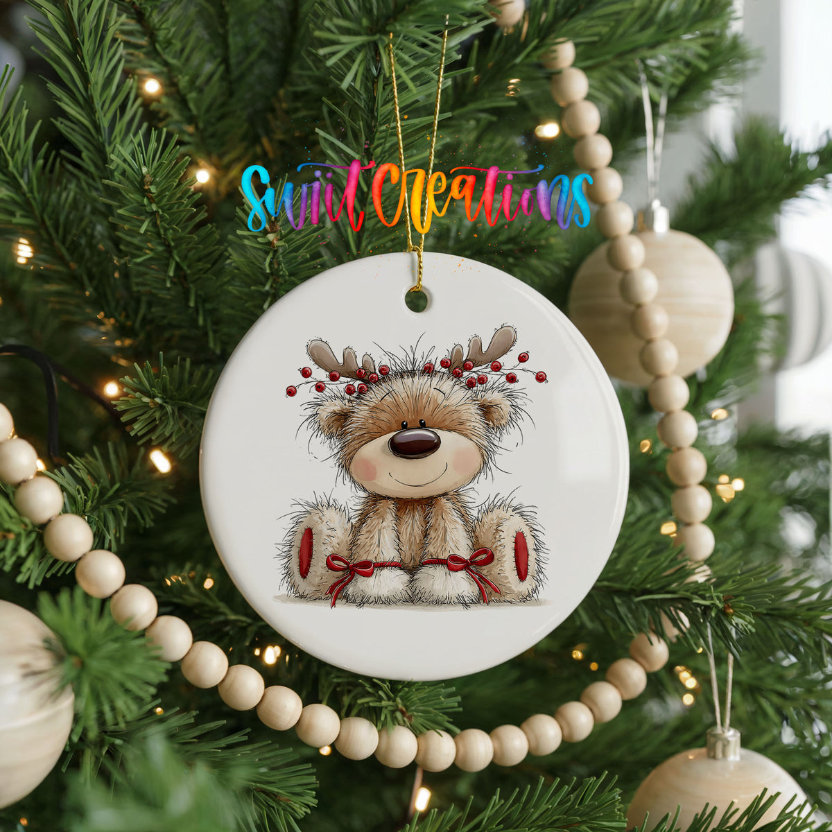 teddy bear wearing reindeer antlers with red winter skis ceramic Christmas ornament hanging on a green Christmas tree