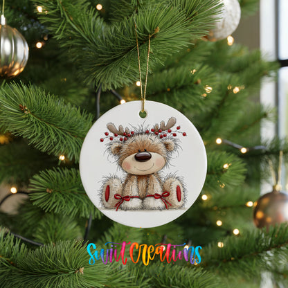 teddy bear wearing reindeer antlers with red winter skis ceramic Christmas ornament hanging on a lit Christmas tree
