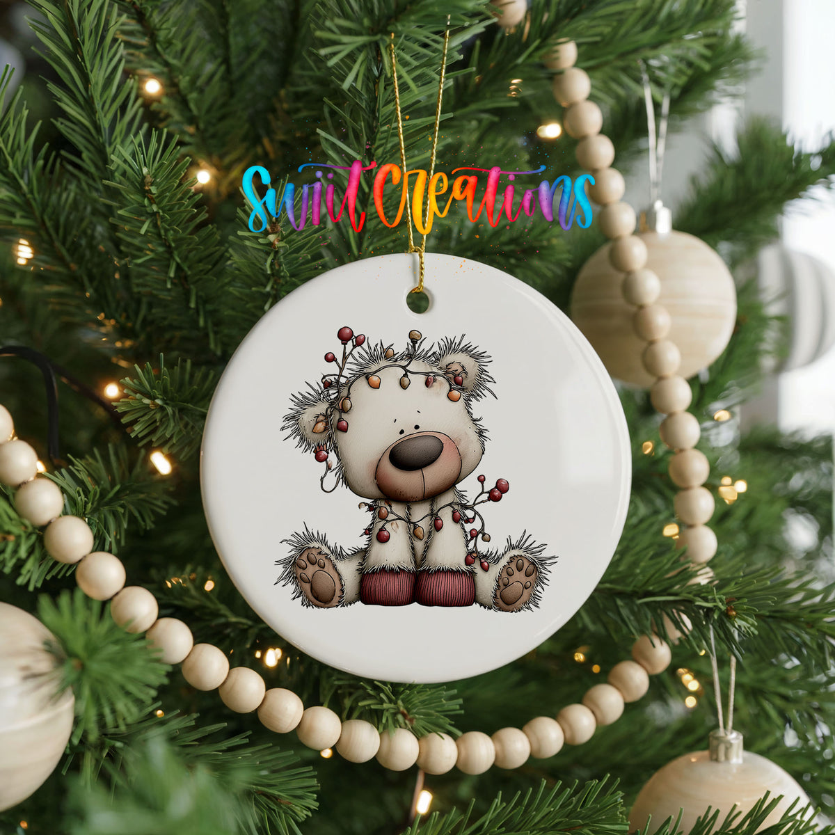 reindeer with decorated antlers and winter ornaments ceramic Christmas ornament hanging on a green Christmas tree