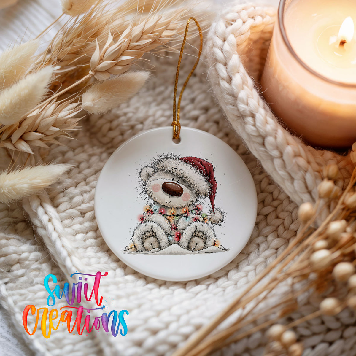 polar bear in a Santa hat and striped scarf ceramic Christmas ornament styled on a cozy knit blanket