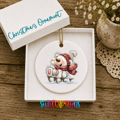polar bear in a red winter scarf playing in the snow ceramic Christmas ornament presented in a gift box