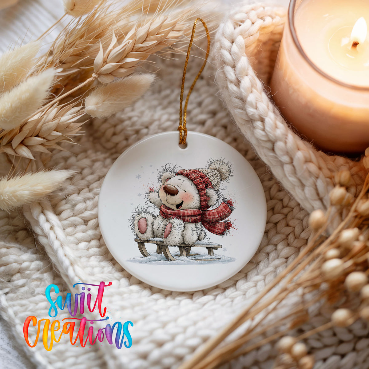 polar bear in a red winter scarf playing in the snow ceramic Christmas ornament styled on a cozy knit blanket