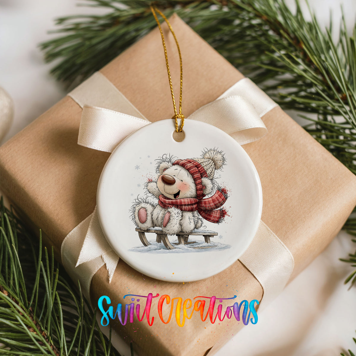 polar bear in a red winter scarf playing in the snow ceramic Christmas ornament displayed on a wrapped Christmas gift