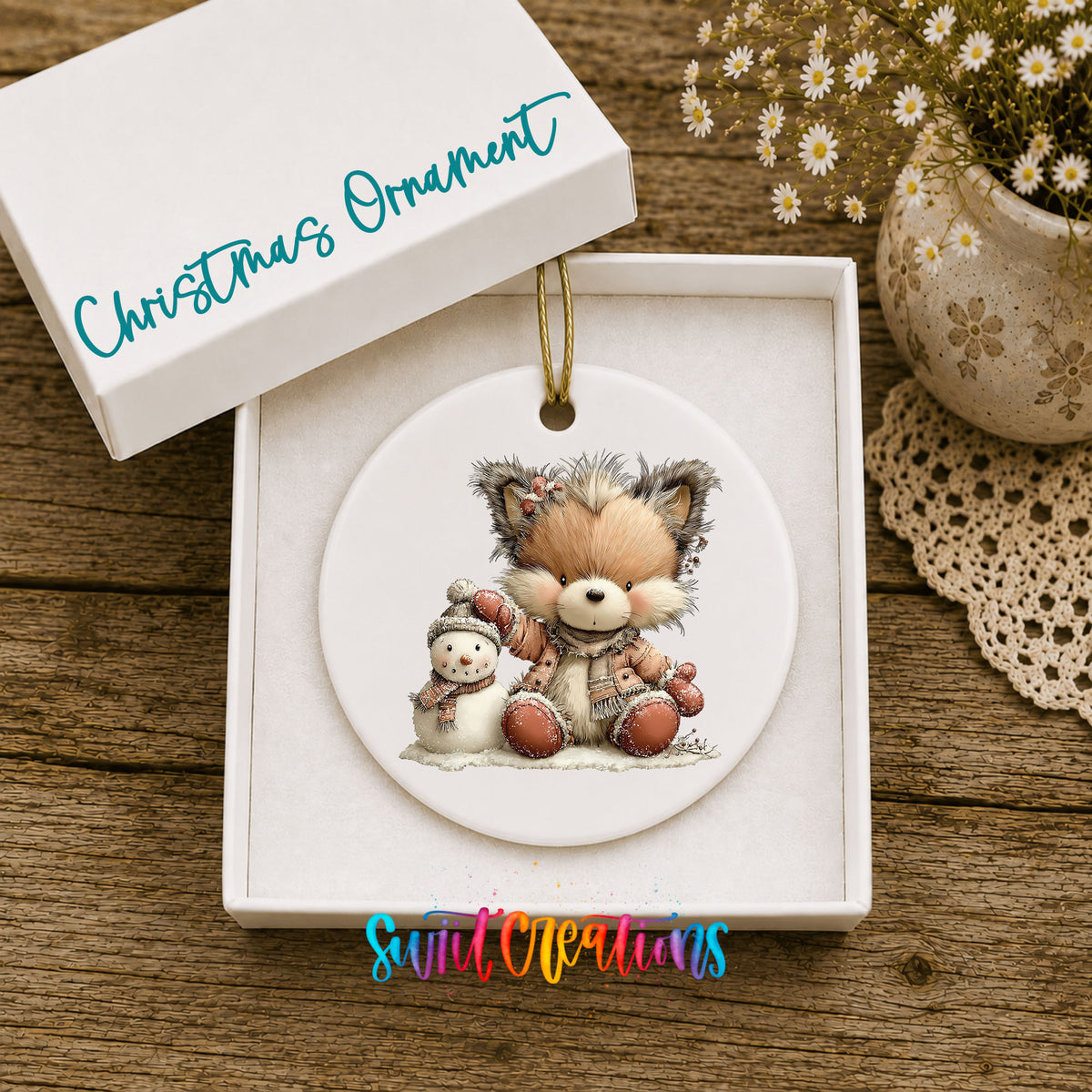 winter fox cuddling a small snowman ceramic Christmas ornament presented in a gift box