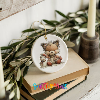 winter fox cuddling a small snowman ceramic Christmas ornament styled on stacked books with greenery