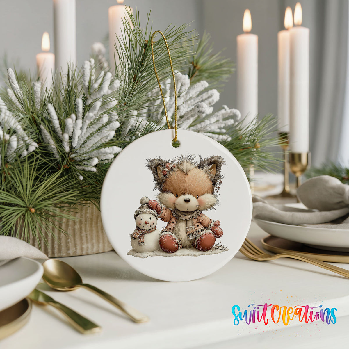 winter fox cuddling a small snowman ceramic Christmas ornament shown in a holiday table setting