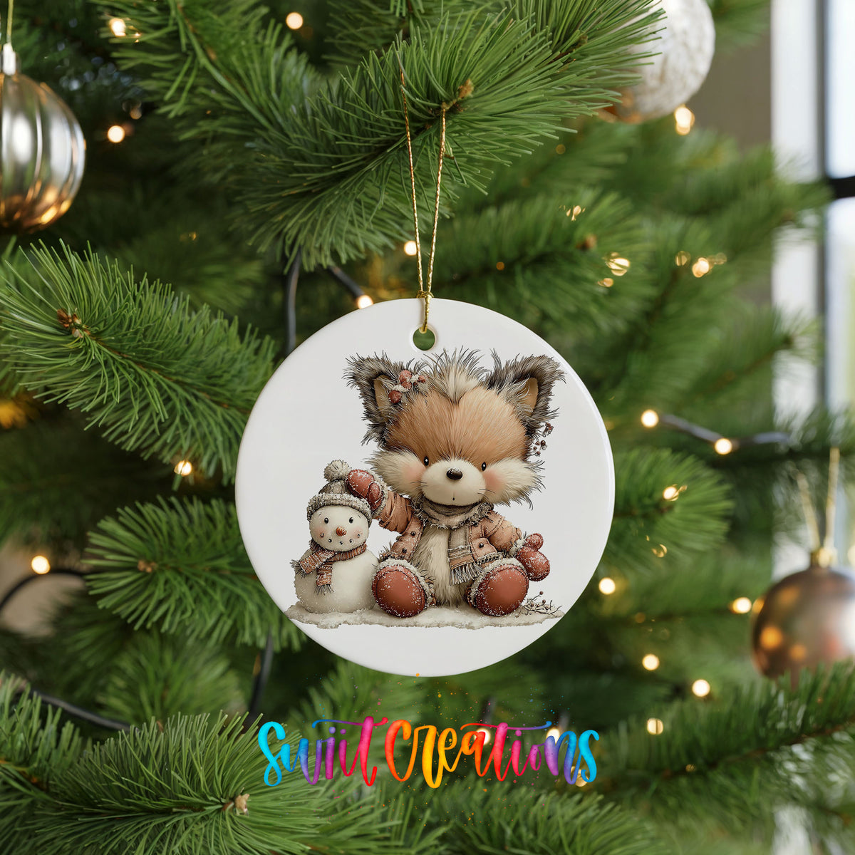 winter fox cuddling a small snowman ceramic Christmas ornament hanging on a lit Christmas tree