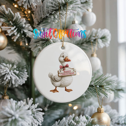 Christmas goose holding a Merry Christmas sign ceramic Christmas ornament hanging on a frosted Christmas tree