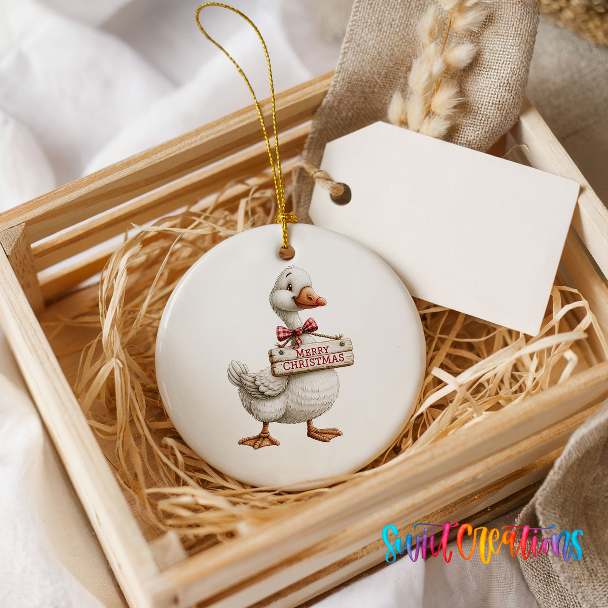 Christmas goose holding a Merry Christmas sign ceramic Christmas ornament displayed in a wooden gift crate