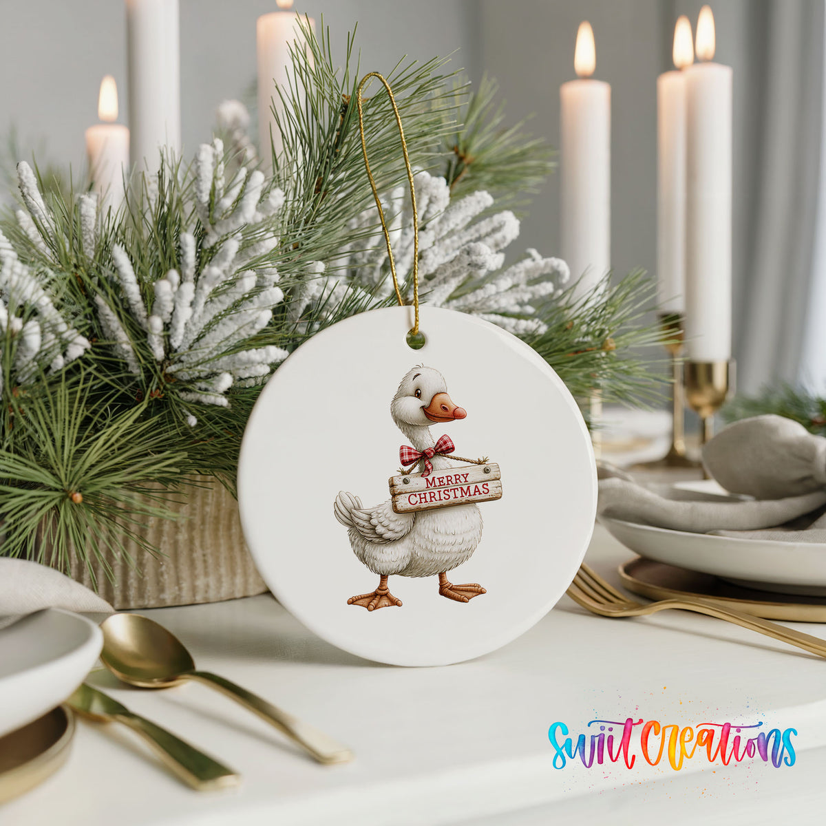 Christmas goose holding a Merry Christmas sign ceramic Christmas ornament shown in a holiday table setting