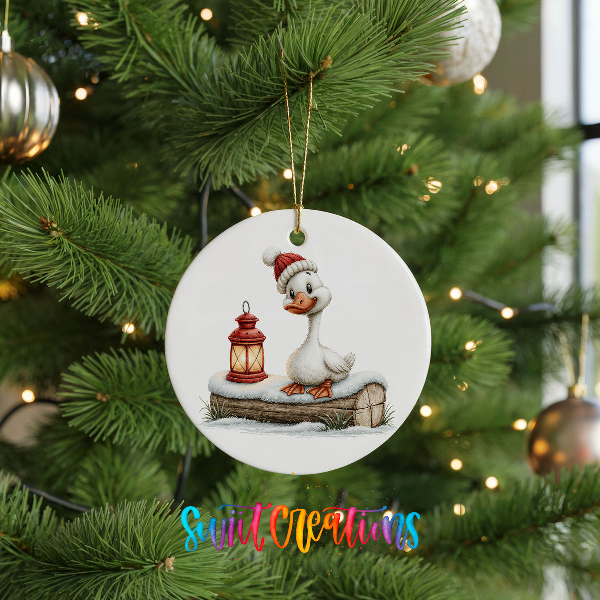 Christmas goose standing beside a red lantern ceramic Christmas ornament hanging on a lit Christmas tree