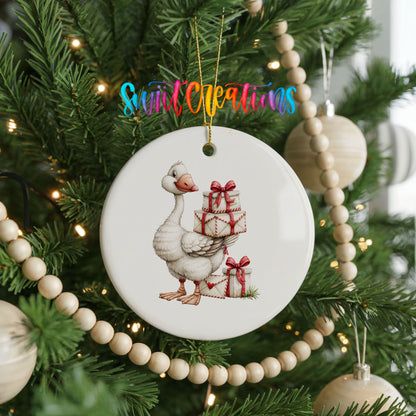 Christmas goose carrying a stack of wrapped gifts ceramic Christmas ornament hanging on a green Christmas tree