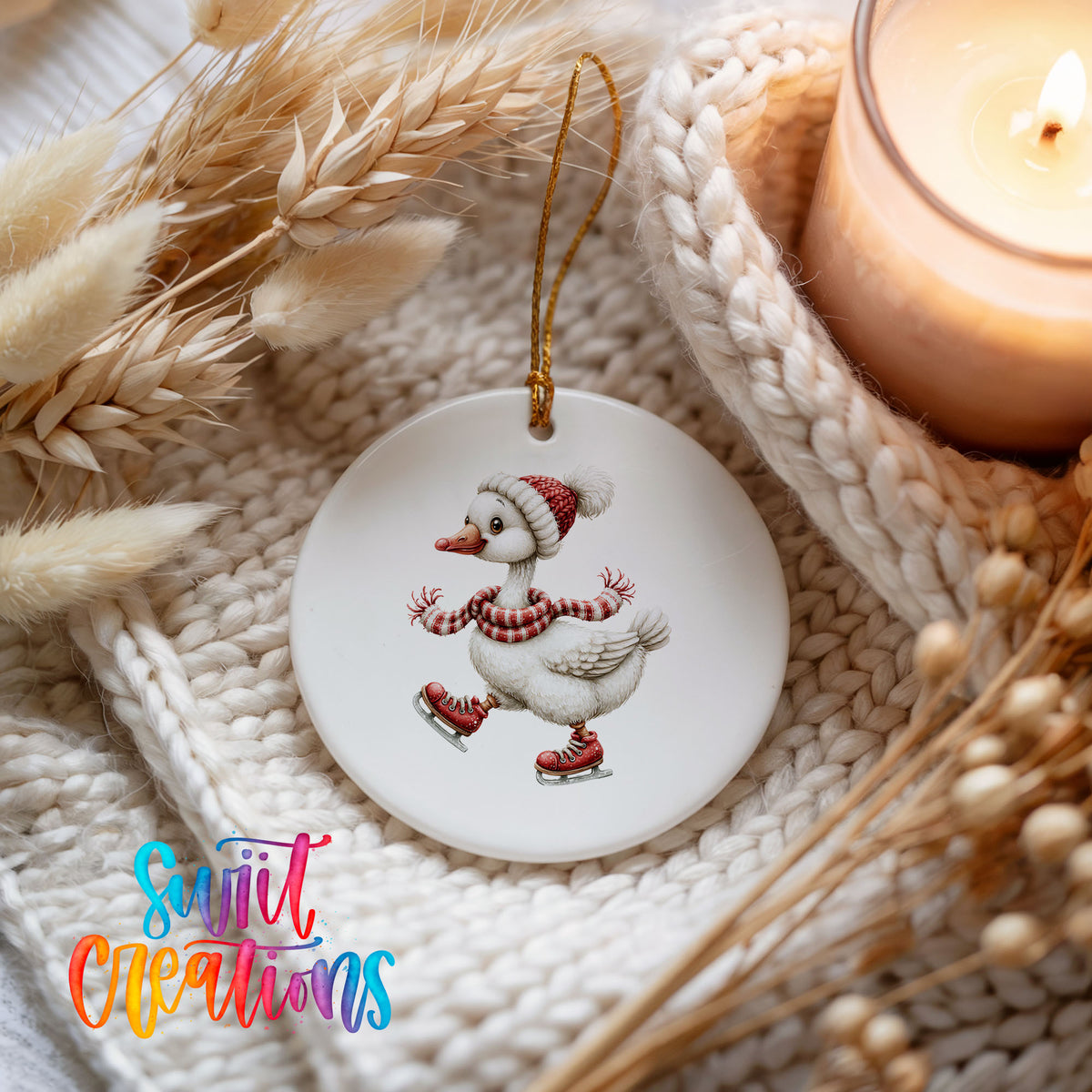 ice skating Christmas goose in a striped scarf ceramic Christmas ornament styled on a cozy knit blanket