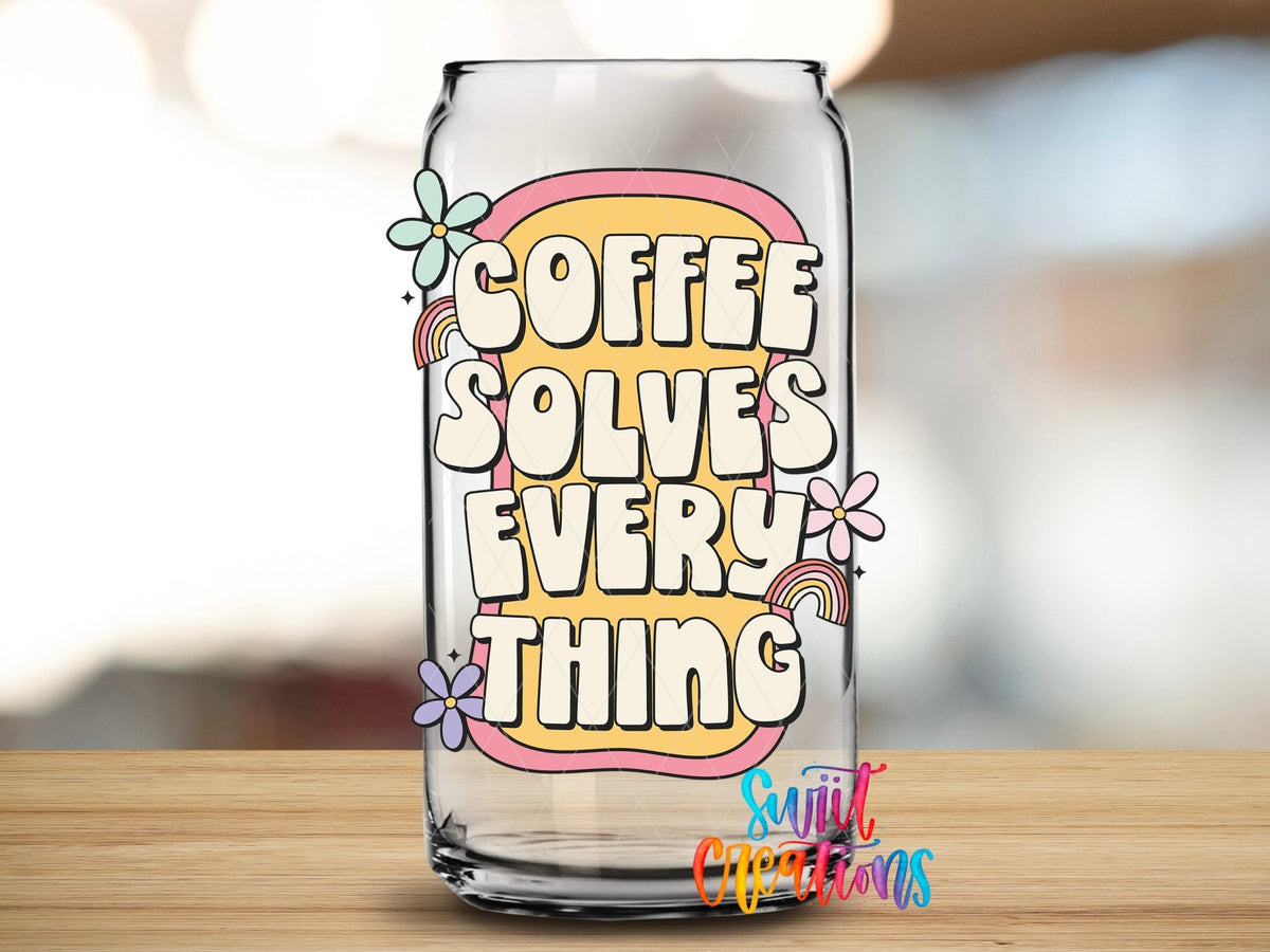 Close-up of the Coffee Solves Everything UV DTF transfer on a clear glass can