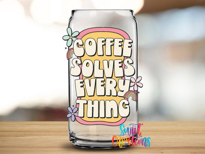 Close-up of the Coffee Solves Everything UV DTF transfer on a clear glass can