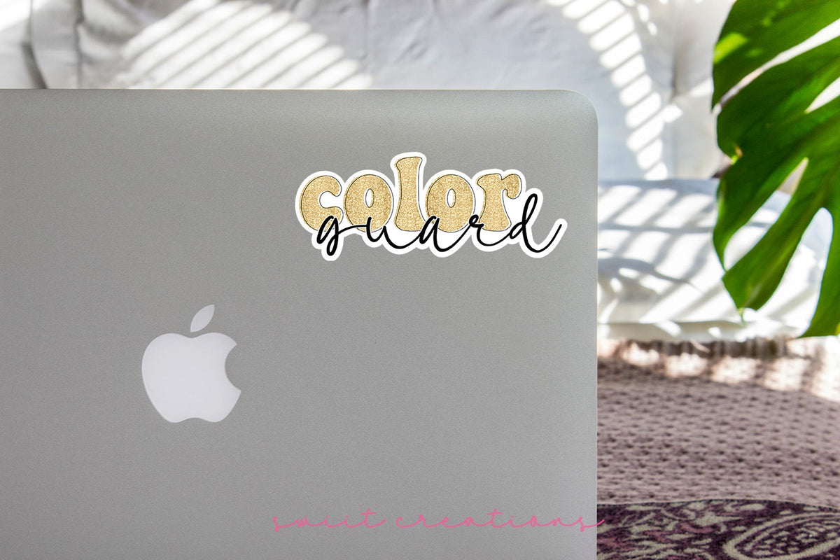 Gold Glitter Color Guard sticker on the lid of a silver laptop