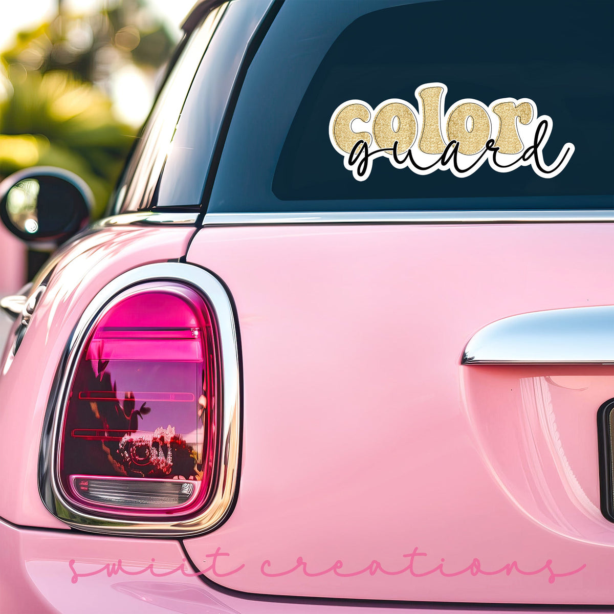 Gold Glitter Color Guard sticker on the back window of a pink car