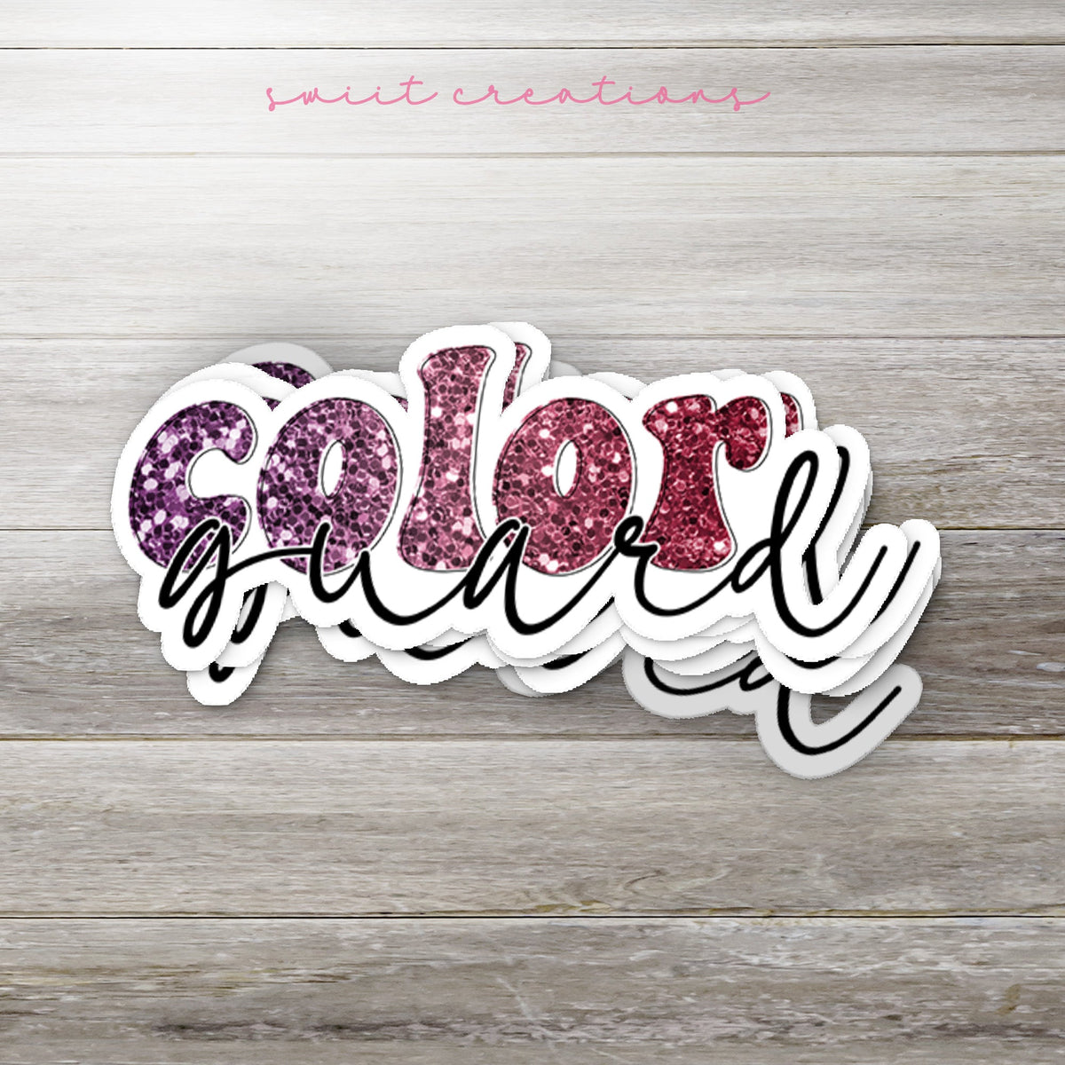Stack of Maroon Glitter Color Guard glossy stickers on a gray wood table