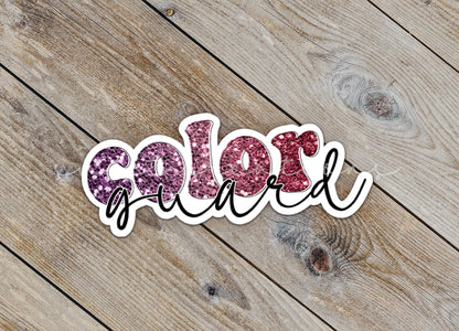 Close-up of the Maroon Glitter Color Guard sticker on rustic wood