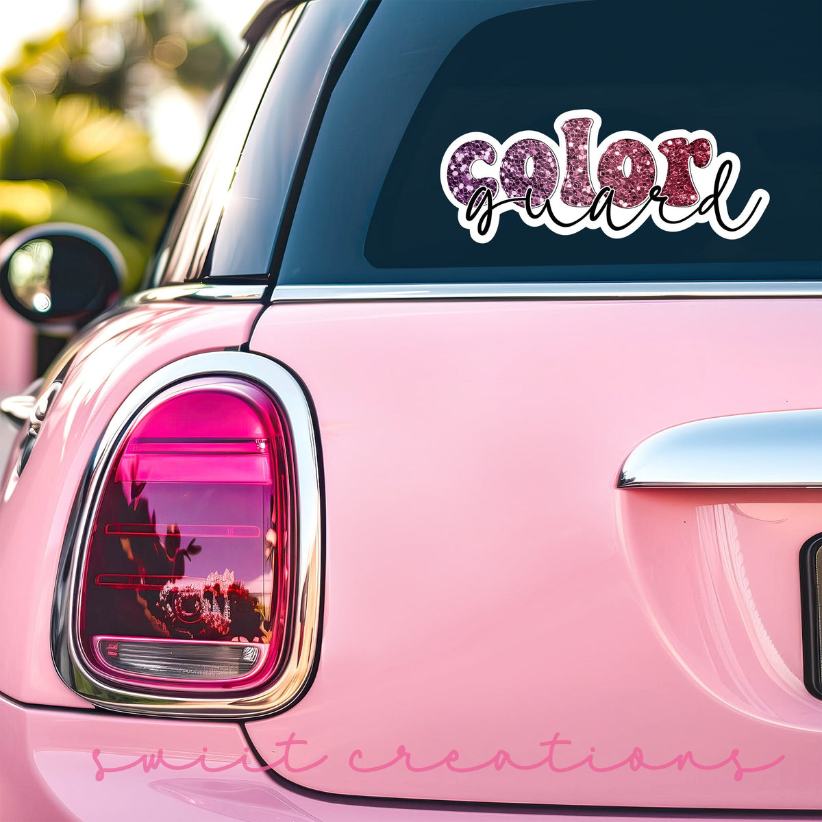 Maroon Glitter Color Guard sticker on the back window of a pink car