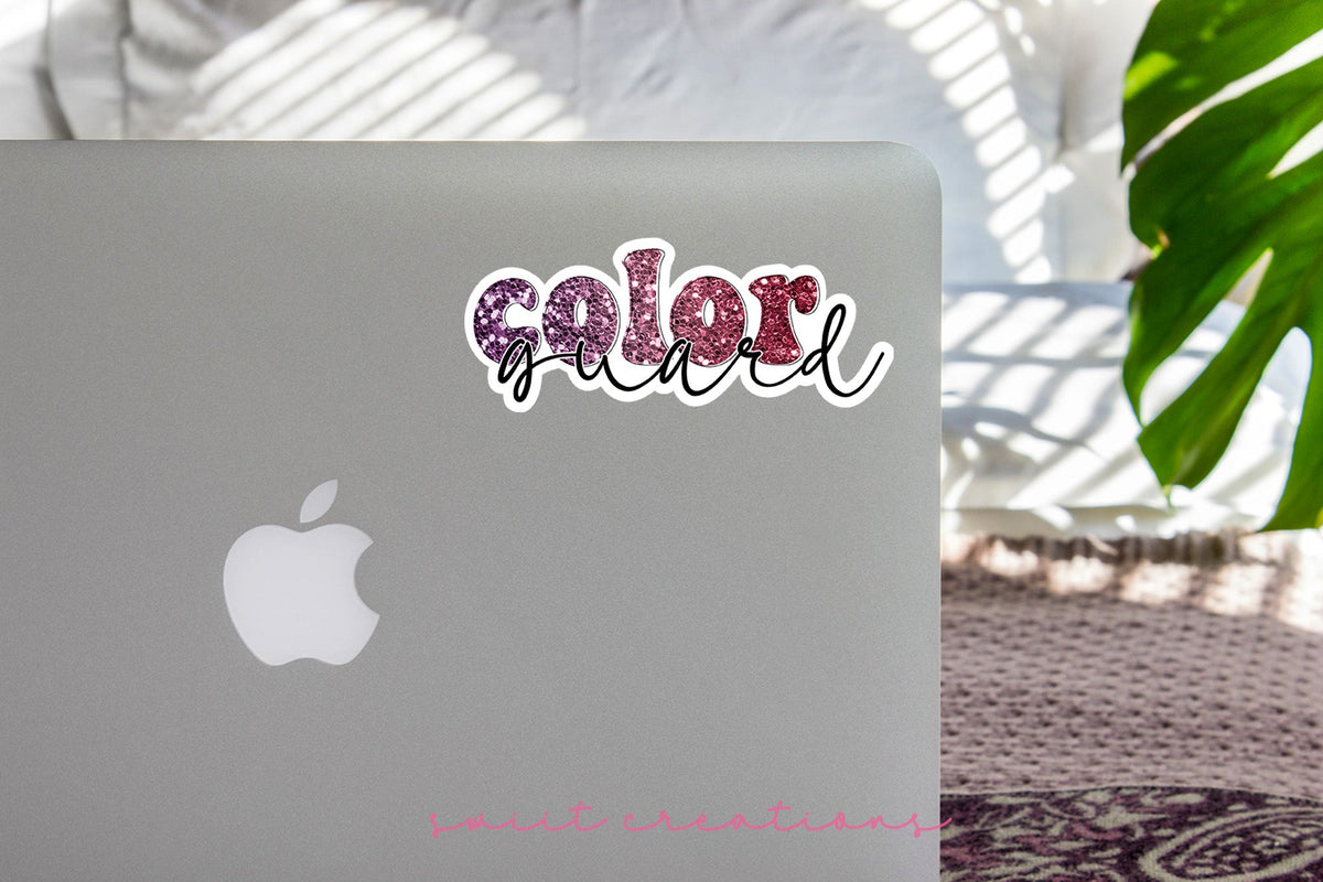 Maroon Glitter Color Guard sticker on the lid of a silver laptop