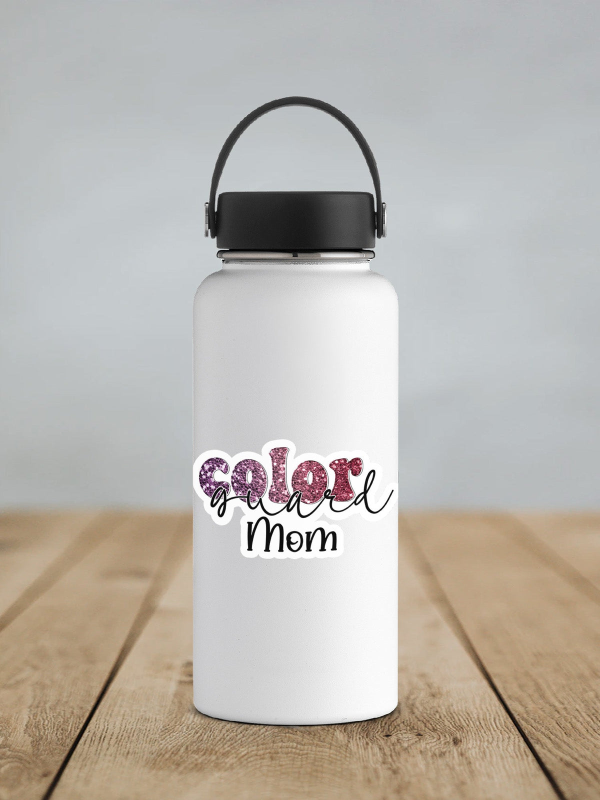 Maroon Glitter Color Guard Mom sticker on a white insulated water bottle