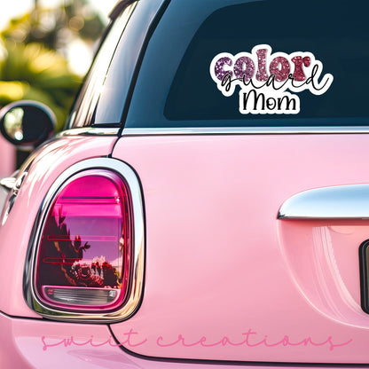Maroon Glitter Color Guard Mom sticker on the back window of a pink car