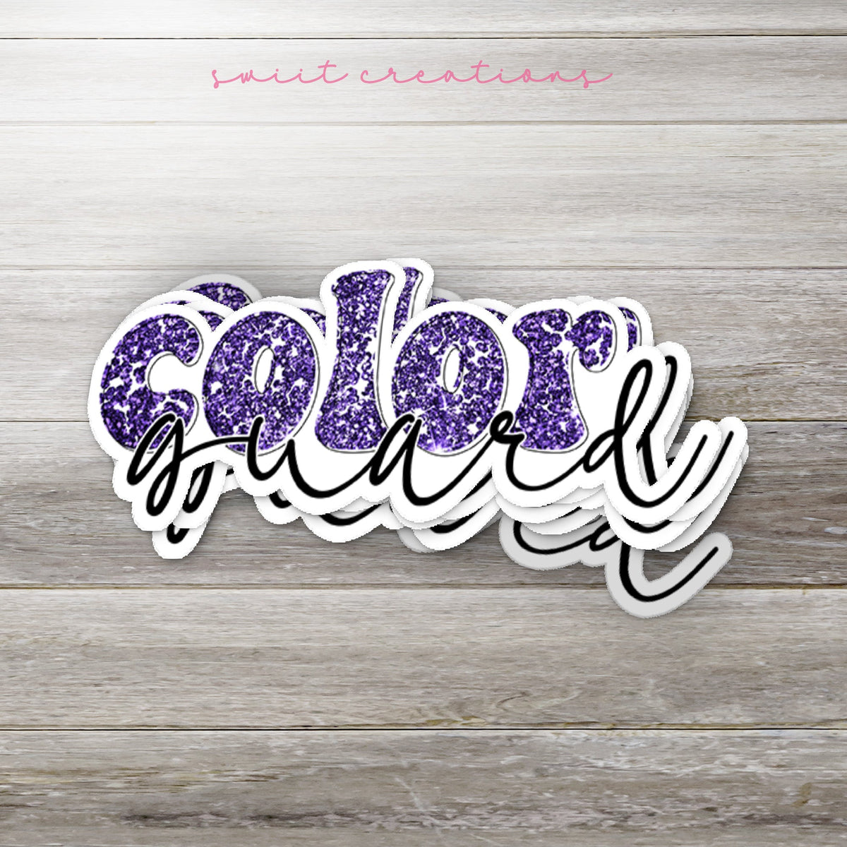 Stack of Purple Glitter Color Guard glossy stickers on a gray wood table