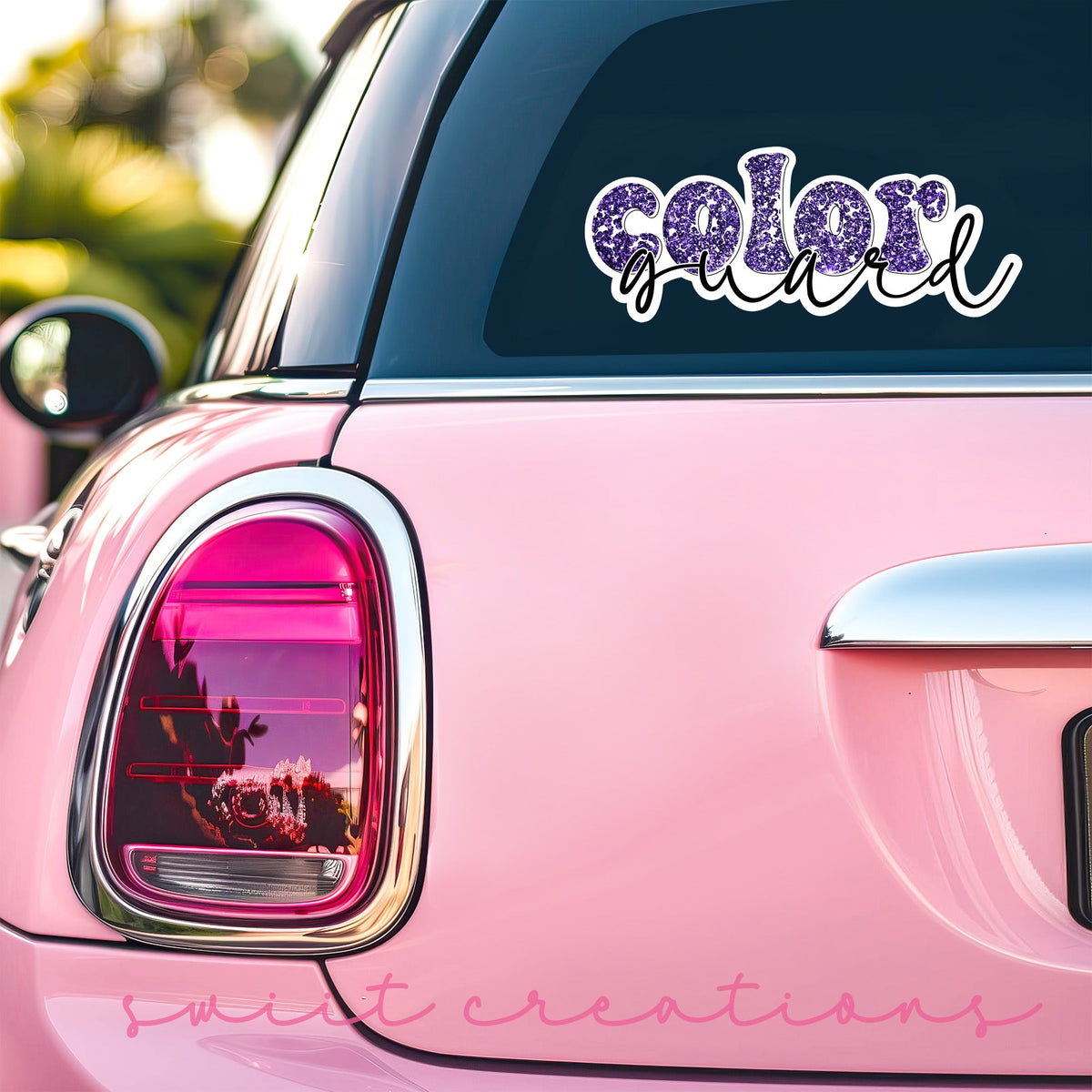 Purple Glitter Color Guard sticker on the back window of a pink car