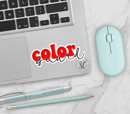 Red Retro Color Guard vinyl sticker on a silver laptop next to a mint mouse and pens