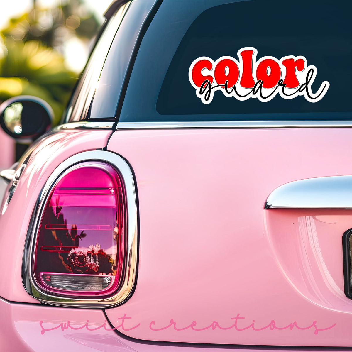Red Retro Color Guard sticker on the back window of a pink car