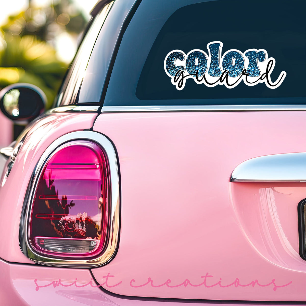 Blue Glitter Color Guard sticker on the back window of a pink car