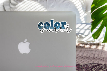 Blue Glitter Color Guard sticker on the lid of a silver laptop
